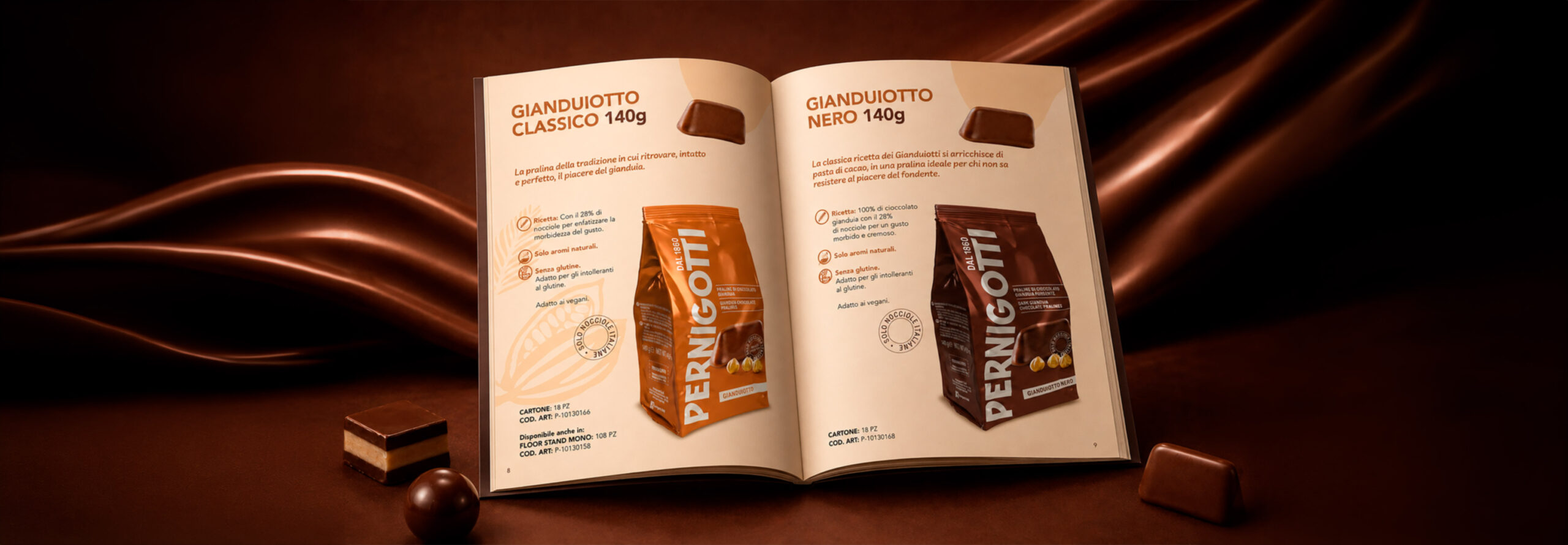 Open magazine showing two pages with chocolate bar packaging, surrounded by chocolate pieces on a brown backdrop.
