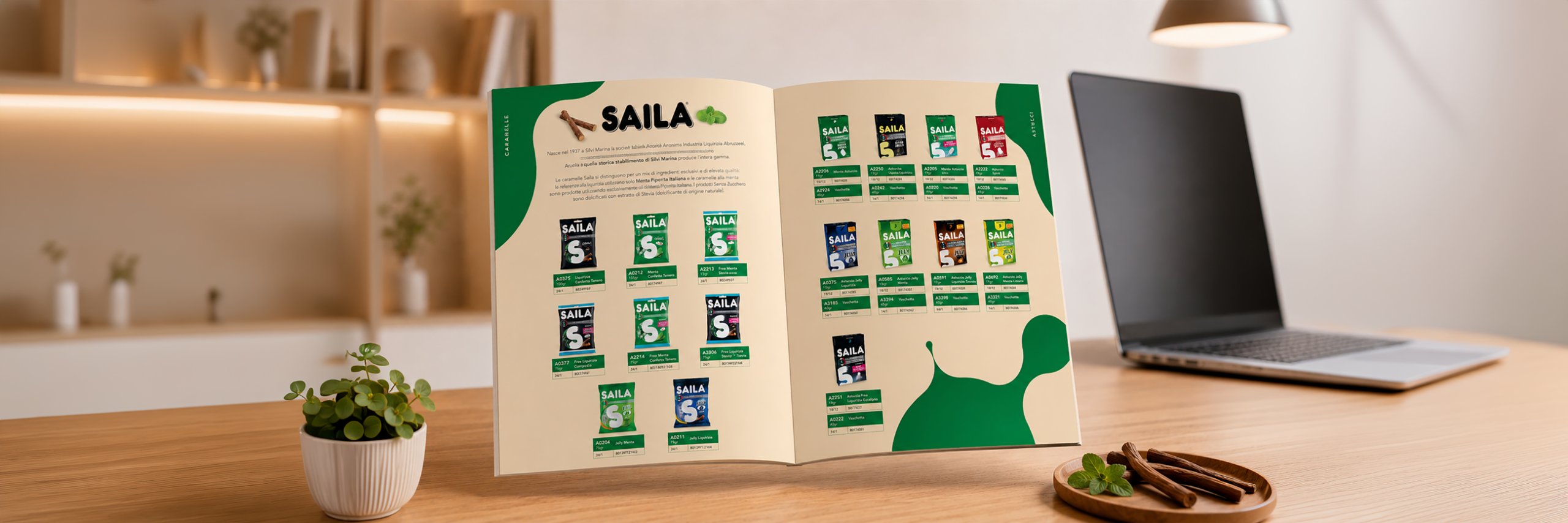 Open product catalog on a wooden table, showing SAILA packets on beige pages with green accents, a small potted plant in the foreground, and a laptop in the background.